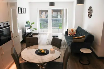 a living room with a table and a couch at The Ivy Abode, Stylish 2-Bed Apartment Free Parking in Harlow