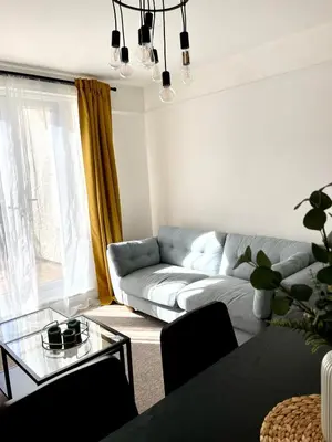 a living room with a couch and a glass table at Spacious 4-Bed Home Near Cambridge City Centre in Chesterton