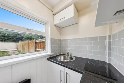 a kitchen with a sink and a window at 3Bed, Sleeps 7, TV in Each Room, Garden, Parking in Basildon