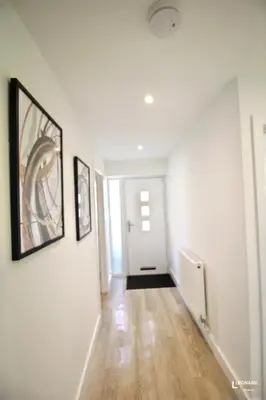 an empty hallway with white walls and wood floors at Bright & Stylish Bungalow Retreat in Attleborough in Attleborough