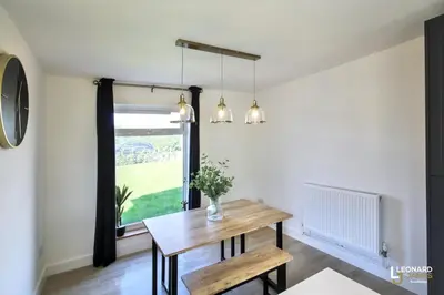 a dining room with a table and a window at Bright & Stylish Bungalow Retreat in Attleborough in Attleborough
