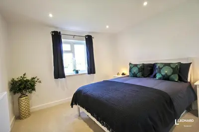 a bedroom with a bed and a window at Bright & Stylish Bungalow Retreat in Attleborough in Attleborough