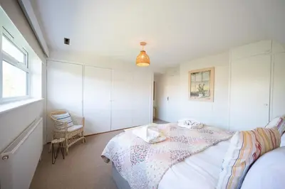 a bedroom with a bed and a window at 5 Church Close (7 guests), Aldeburgh in Aldeburgh