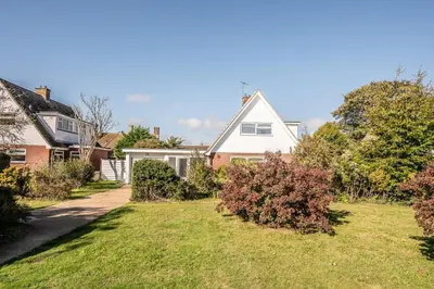 a house with a lawn in a residential neighborhood at 5 Church Close (7 guests), Aldeburgh in Aldeburgh