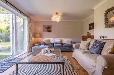 a living room with a couch and a table at 5 Church Close (7 guests), Aldeburgh in Aldeburgh