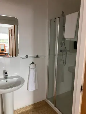 a bathroom with a shower and a sink at White hart public house in Ashill