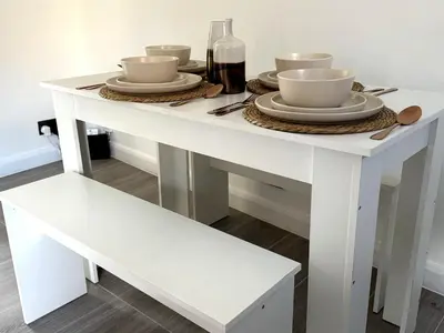 a white table with bowls and plates on it at Cosy Central Colchester Home by Castle Park in Colchester