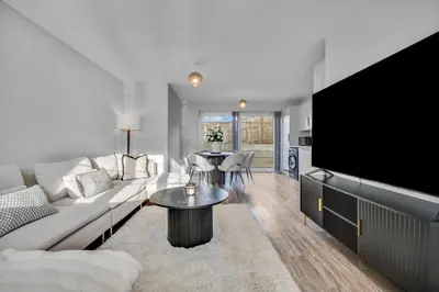 a living room with a couch and a tv at Lovely 2-Bed House with parking in Broomfield