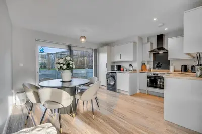 a kitchen and dining room with a table and chairs at Lovely 2-Bed House with parking in Broomfield