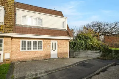 a brick house with a white door and a driveway at Lovely 2-Bed House with parking in Broomfield