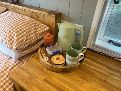 a tray with cups and other items on a table at Shepherds hut in Holywell Cambridgeshire in Holywell