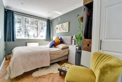 a small bedroom with a bed and a chair at Charming 4 bedroom home in Felsted in Felsted