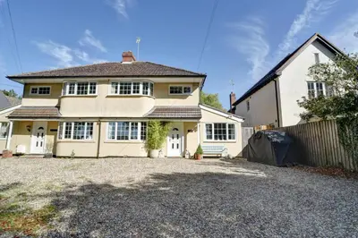 a large white house with a driveway at Charming 4 bedroom home in Felsted in Felsted