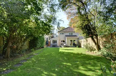 a house with a yard with green grass and trees at Charming 4 bedroom home in Felsted in Felsted