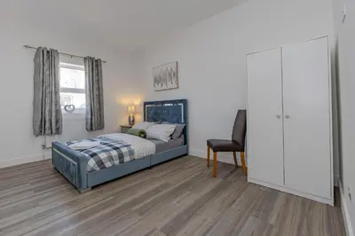 a bedroom with a bed and a desk and a chair at Triple B Aparto in Clacton-on-Sea