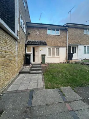 a brick house with a white door and a yard at 3 Bed Home, Sleeps 7 with Garden in Basildon in Basildon
