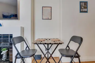 two chairs and a table in a room at The Old Shoe Shop, 5 Well Lane in Clare