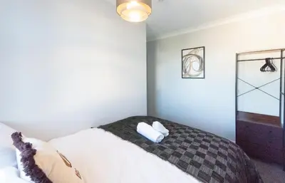 a bedroom with a bed with two pillows on it at 4 Bedroom Home - 2 Mins to Town CM7 - Contractor Ready in Braintree