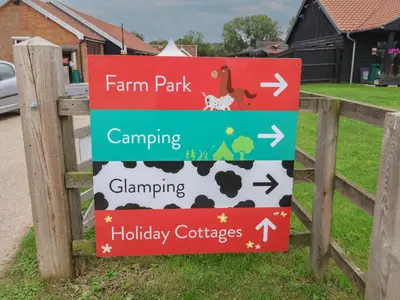a sign for a farm park on a fence at Duchess Cottage in Woodbridge
