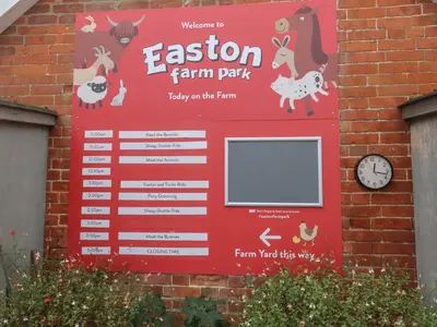 a sign for a farm park on a brick wall at Duke Cottage in Woodbridge