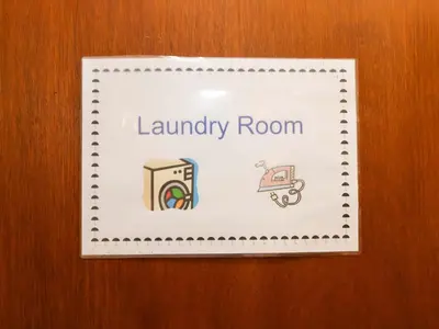 a sign for a laundry room on a wooden door at Hayloft in Ipswich
