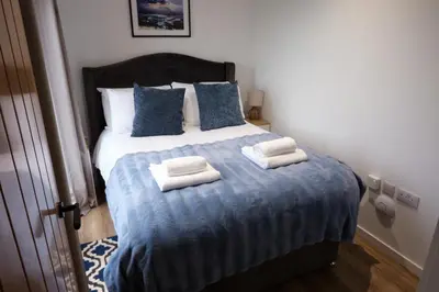 a bedroom with a bed with towels on it at The Granary Estates