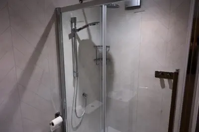 a shower with a glass door in a bathroom at The Granary Estates