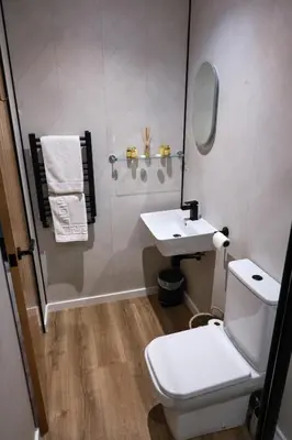 a bathroom with a white toilet and a sink at The Granary Estates