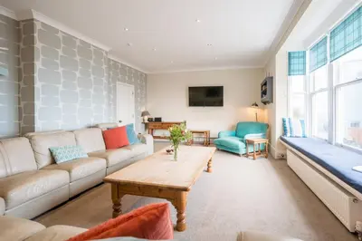 a living room with a couch and a table at Orlando, Aldeburgh in Aldeburgh