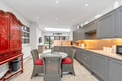 a kitchen with a table and chairs and a counter at GROUND floor apartment no steps 119 Northgate St luxury 2 bedroom apartment close to the town centre with paid parking close by in Bury Saint Edmunds
