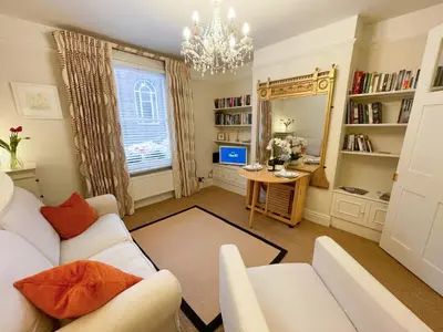 a living room with a white couch and a table at Luxury Boutique 'Duchess Suite' in Historic Centre in Cambridge