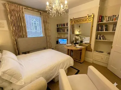 a bedroom with a bed and a desk and a mirror at Luxury Boutique 'Duchess Suite' in Historic Centre in Cambridge