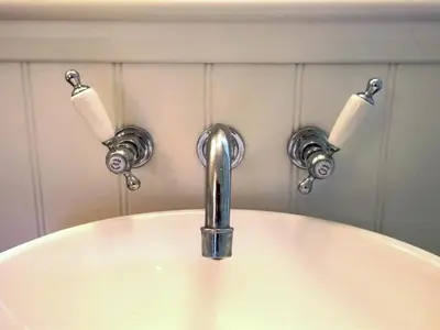 a sink with a faucet and three rolls of toilet paper at Guest Rooms at The Green Man in Takeley
