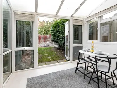 a conservatory with a table and chairs on a patio at Pass the Keys Cosy home Basildon Ideal for contractors in Basildon