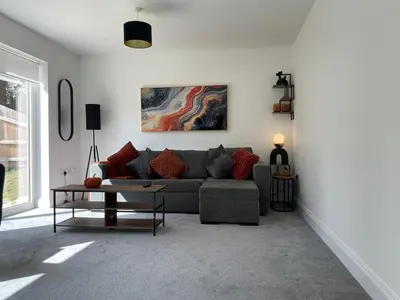 a living room with a couch and a table at Iris Cottage 4BR Coastal Retreat in Wenhaston