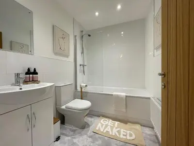 a bathroom with a tub and a toilet and a sink at Iris Cottage 4BR Coastal Retreat in Wenhaston