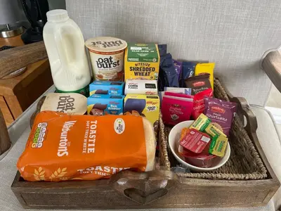 a basket filled with food and a bottle of milk at Woodland View in East Harling