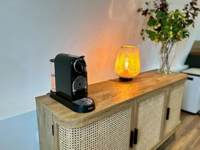 a table with a camera and a lamp on it at Luxury Retreat with Spa Access - Sleeps 6 in Peldon
