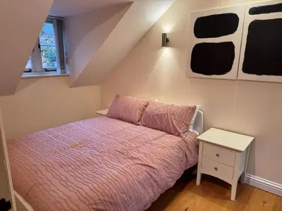 a small bedroom with a bed and a night stand at 4 bed Townhouse in Central Bury St Edmunds in Bury Saint Edmunds