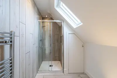 a shower in a bathroom with a glass door at Chicoutimi 4 in Thorpeness