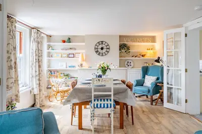 a living room with a table and chairs at Sanderlings 4 in Aldeburgh