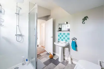 a bathroom with a sink and a shower at Sanderlings 4 in Aldeburgh