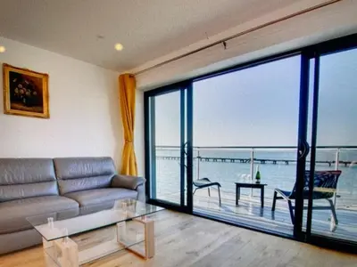 a living room with a couch and a view of the ocean at Admirals in Shotley Gate