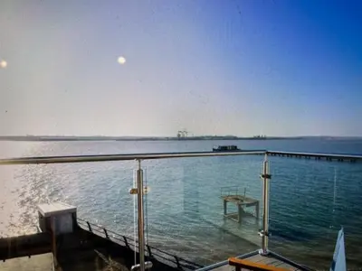a dock with a table in the water at Admirals in Shotley Gate