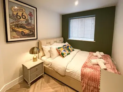 a small bedroom with a bed and a window at Luxury 2 bed new-build house near Science & Business parks in Cambridge