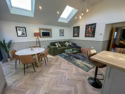 a living room with a couch and a table at Luxury 2 bed new-build house near Science & Business parks in Cambridge