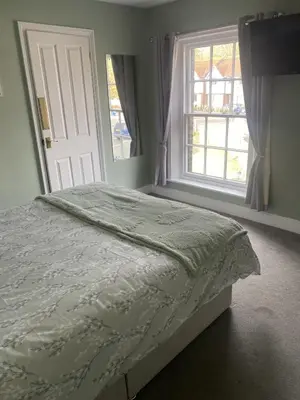 a bedroom with a bed and a large window at The Golden Boar Inn in Freckenham