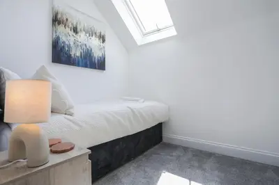 a bedroom with a bed and a window at Iris Group Stay 8-BR Free Parking in Wenhaston