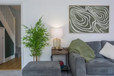a living room with a couch and a plant at Iris Group Stay 8-BR Free Parking in Wenhaston