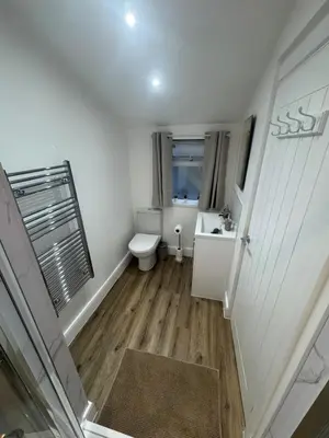 a small bathroom with a toilet and a sink at Cinema room apartment 1 in Basildon